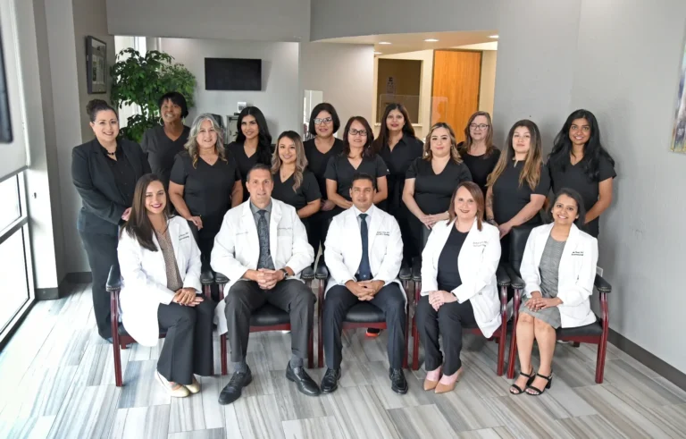 Team of medical professionals and staff posing together.