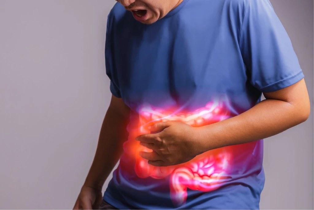 Man clutching stomach with glowing intestine graphic.