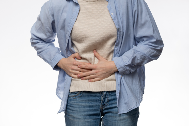 person in blue shirt holding his stomach.