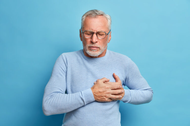 senior-man-spectacles-presses-hand-chest-has-heart-attack-suffers-from-unbearable-pain
