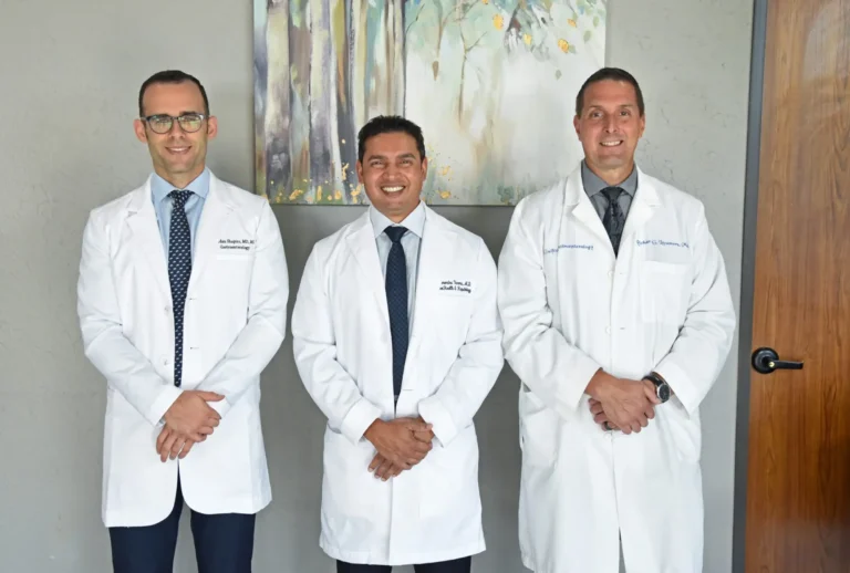 Medical team in white coats posing together.